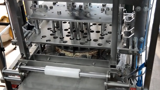 Universal, automatic cutter for wafers layered with cream, cutting into triangles and squares.